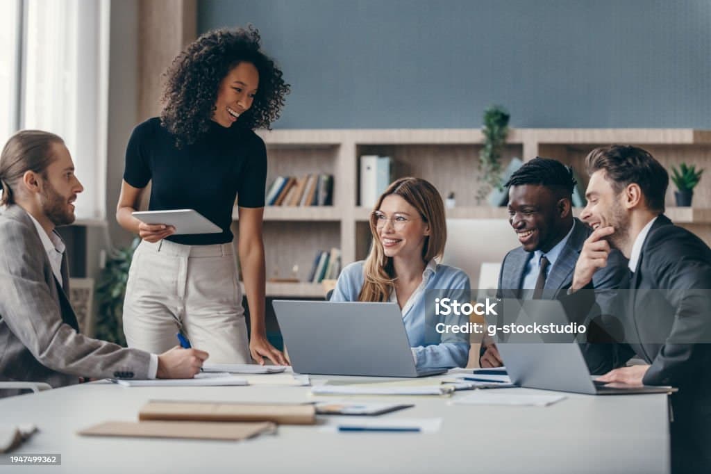 Team collaborating around a laptop during an accessibility review